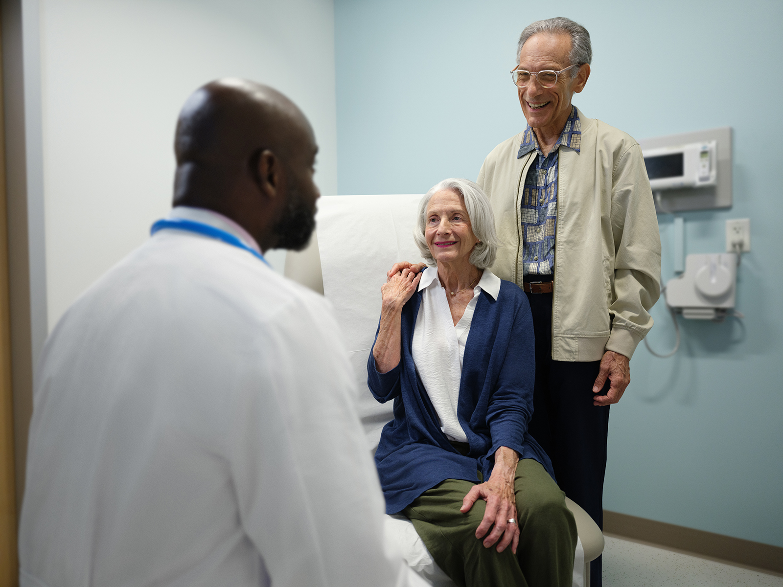 Patients with doctor in exam room