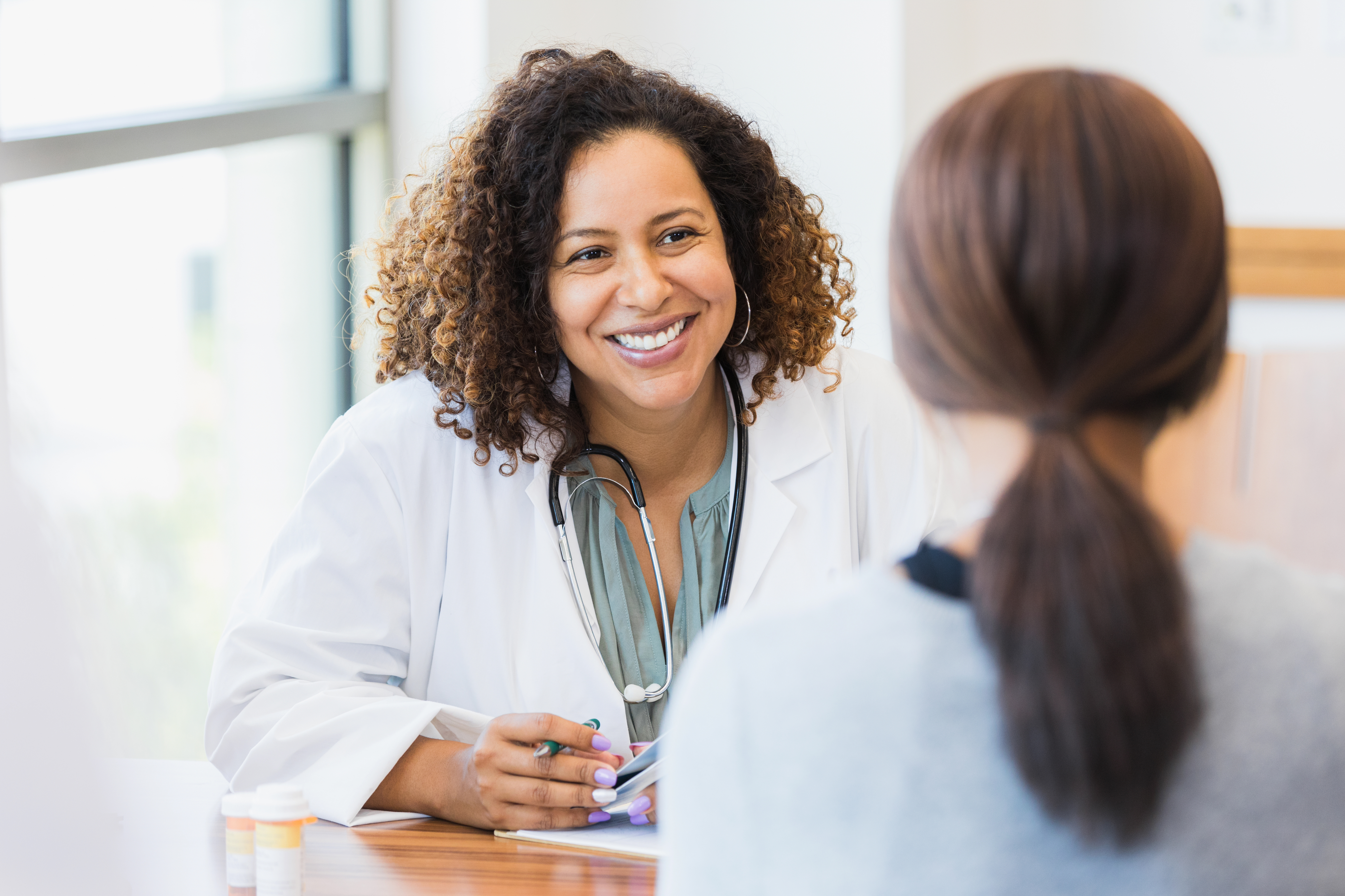 Doctor chatting with patient kind smile