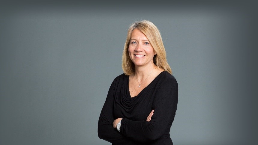 portrait of nurse practitioner Jacquelyn Plick crossing her arms and smiling