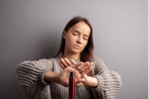 teenager refusing vape smoking, stop electronic cigarette, teenager shows a sign of rejection of disposable e-cigarette with her hand
