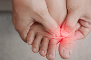Person pressing on a blister between the toes