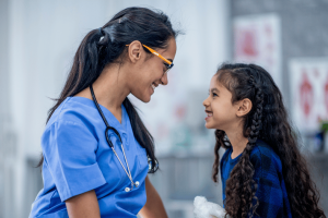 Summit Health pediatrician examining a child with joint pain concerns in a friendly medical office setting
